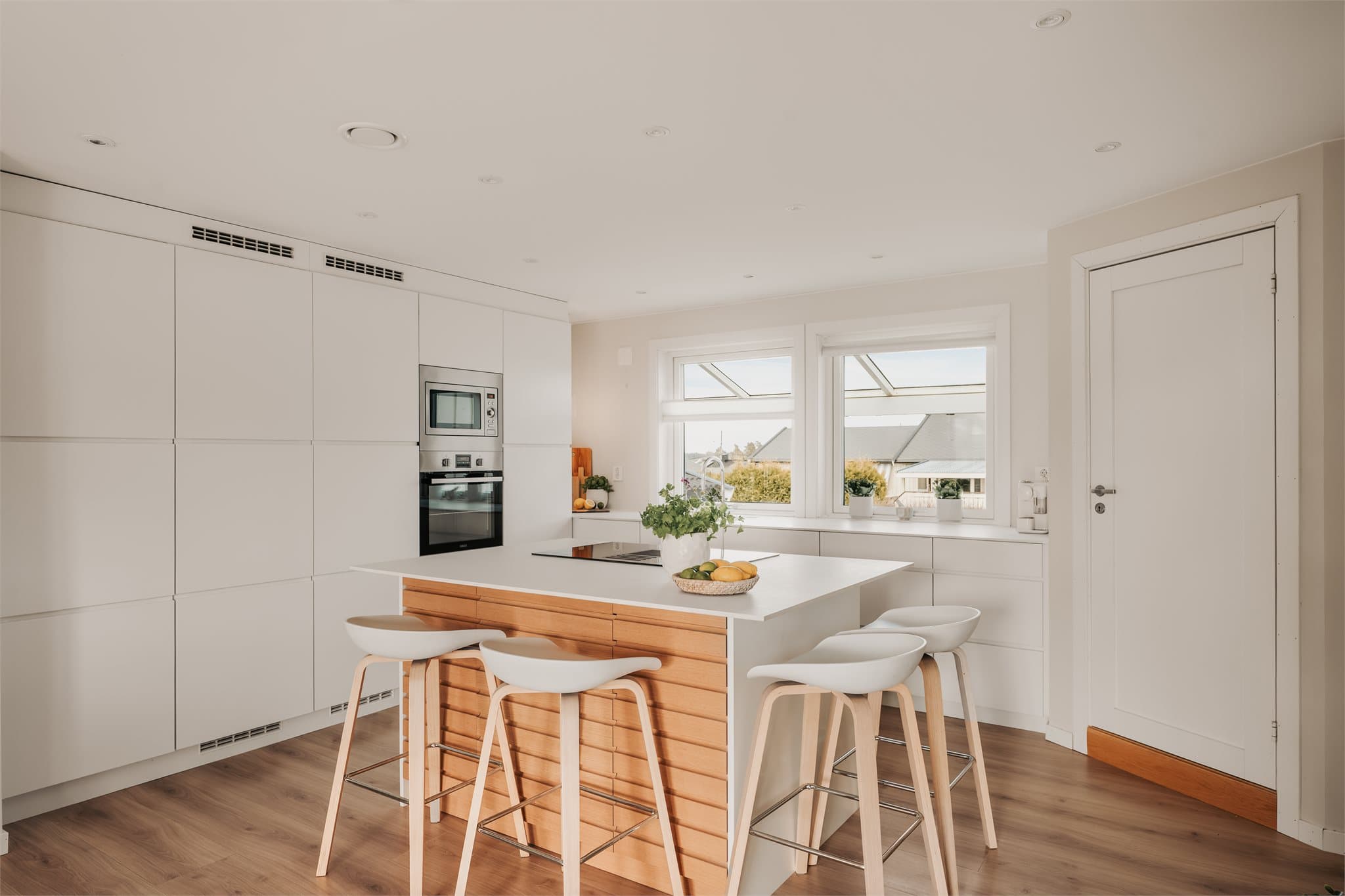 Sentralt på kjøkkenet er det en kjøkkenøy med tilhørende barløsning.