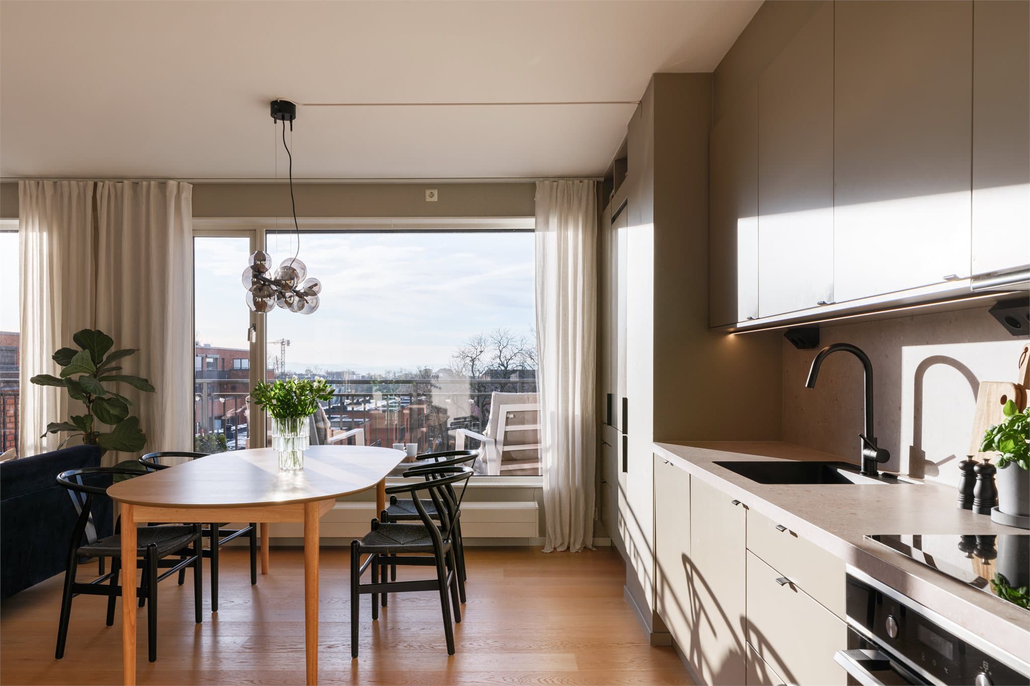 Langstrakt kjøkken med plass til stort spisebord – perfekt til både måltider og samlinger.