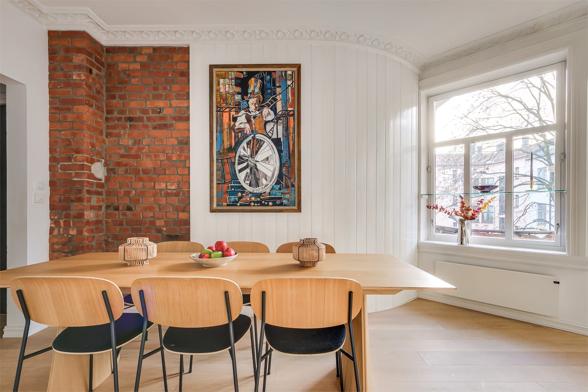 Den buede veggen med panel er en sjarmerende detalj som gir rommet et klassisk særpreg.