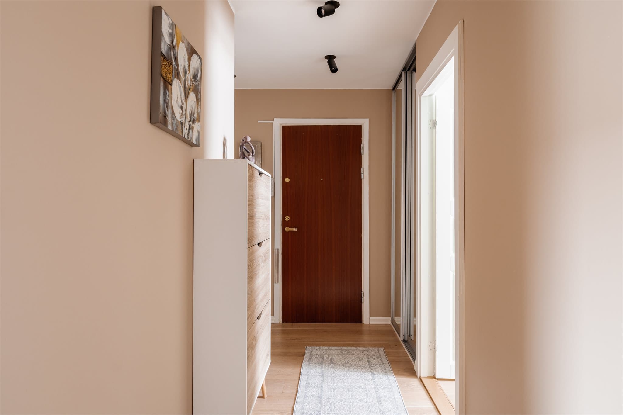 En lys entré med nedsenket himling og downlights ønsker velkommen. Ny låsekasse i utgangsdør ble montert i 2025.