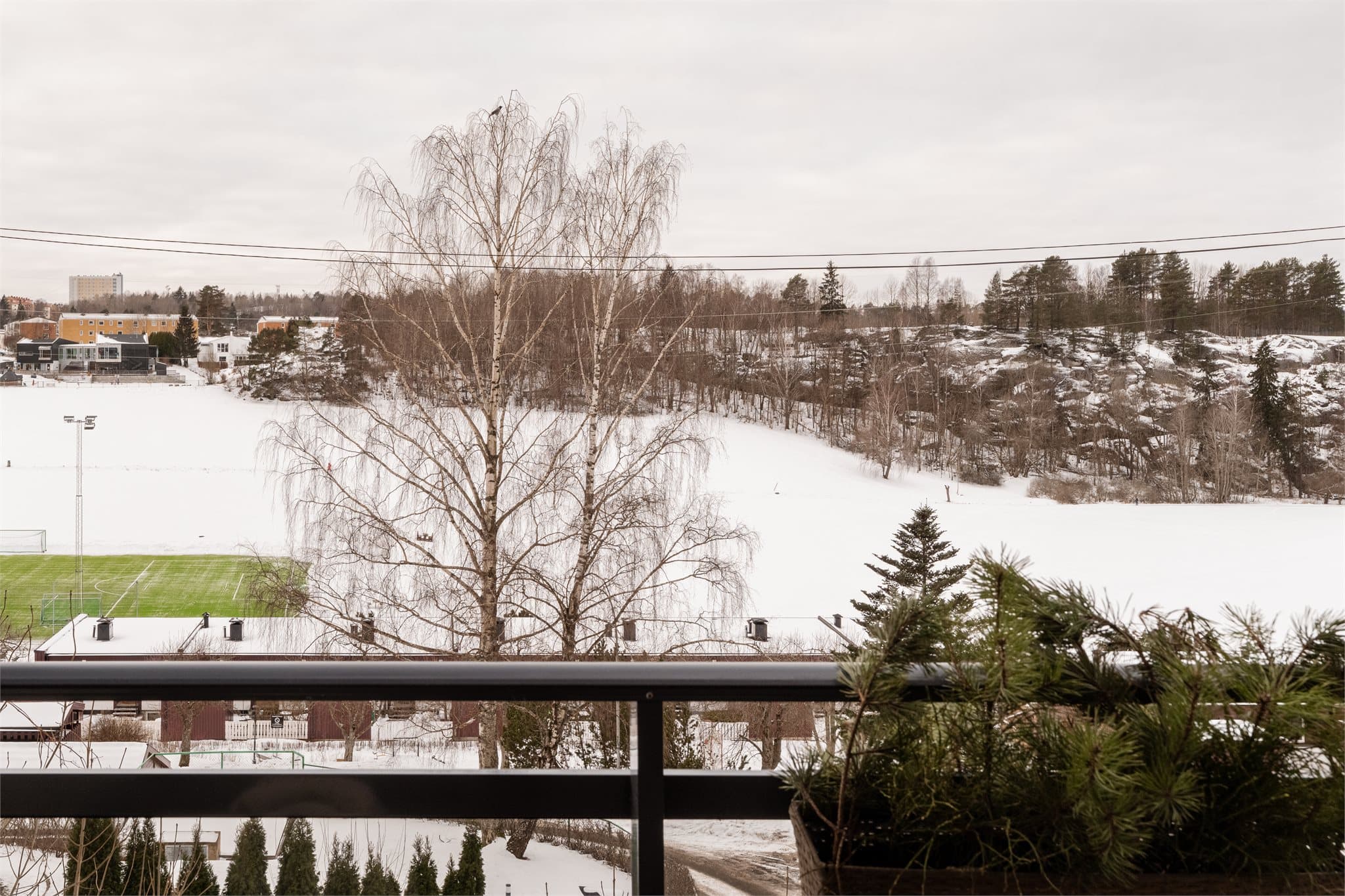 Fra balkongen ser man mot Rustad idrettsanlegg med fotballbaner, kun få minutter unna.
