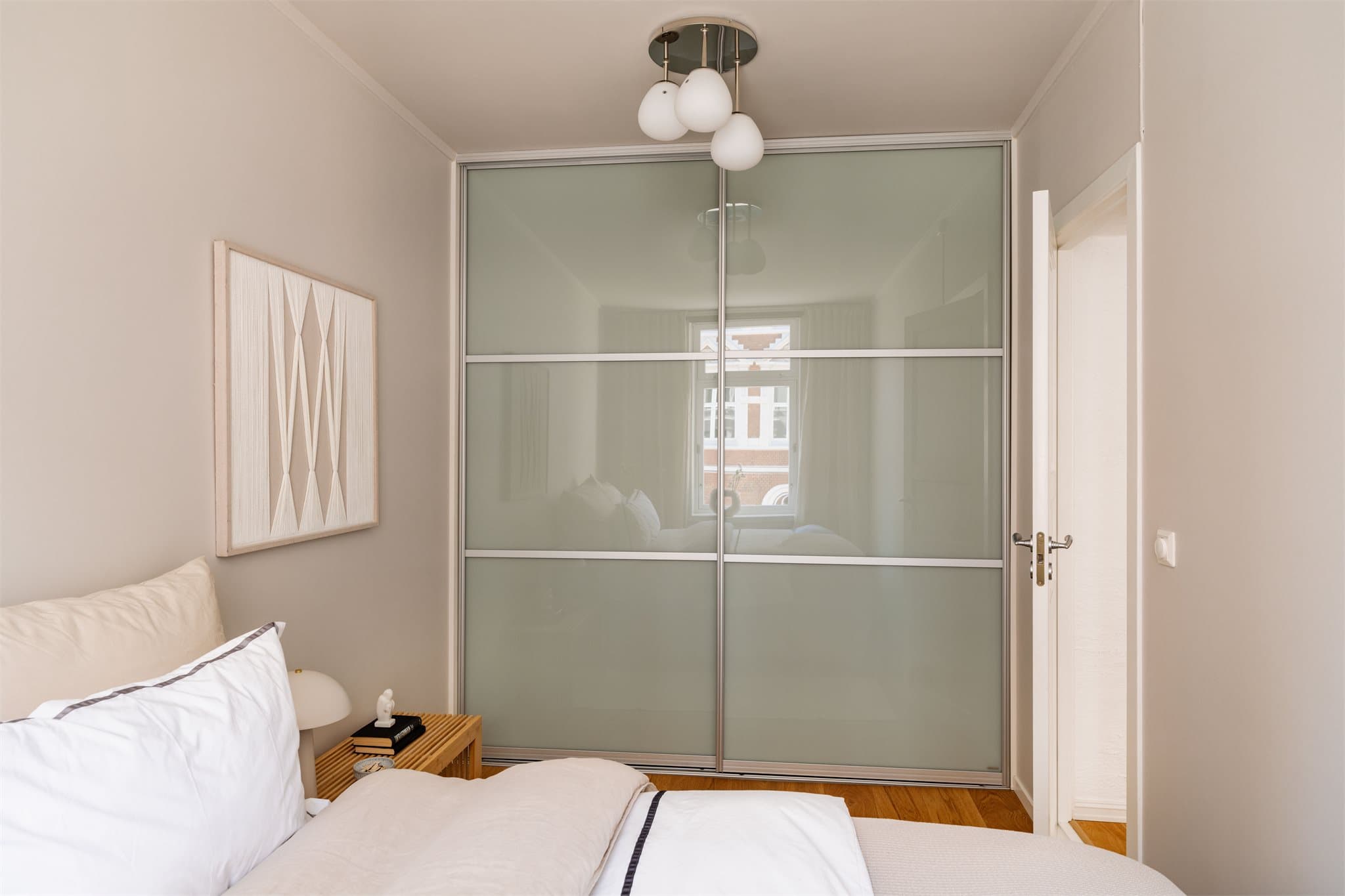 Hovedsoverommet har plass til dobbeltseng med tilhørende nattbord og er utstyrt med en praktisk, plassbygget skyvedørsgarderobe som gir rikelig oppbevaringsplass.