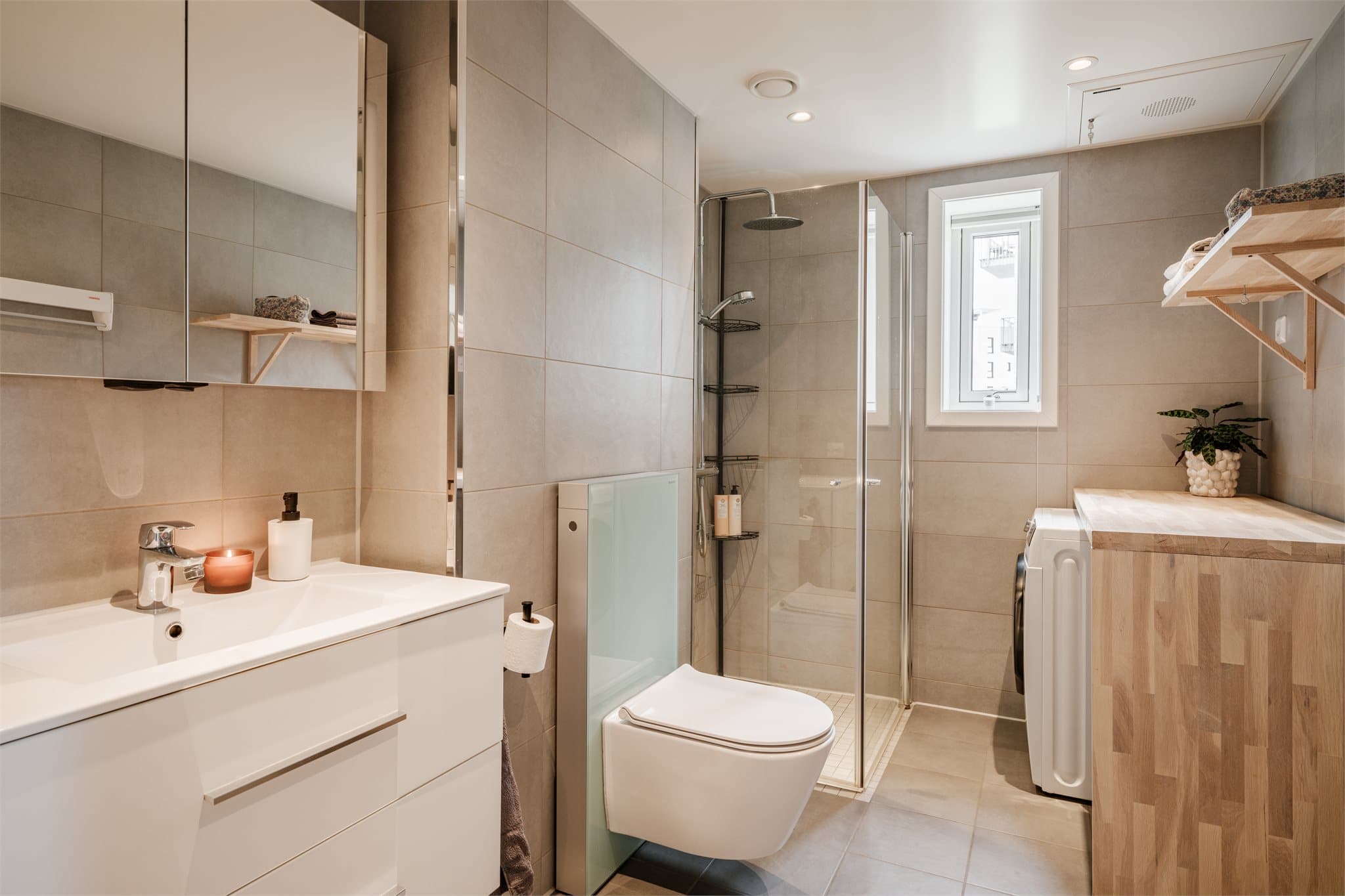 Lekkert baderom med elektriske varmekabler og flislagte overflater.