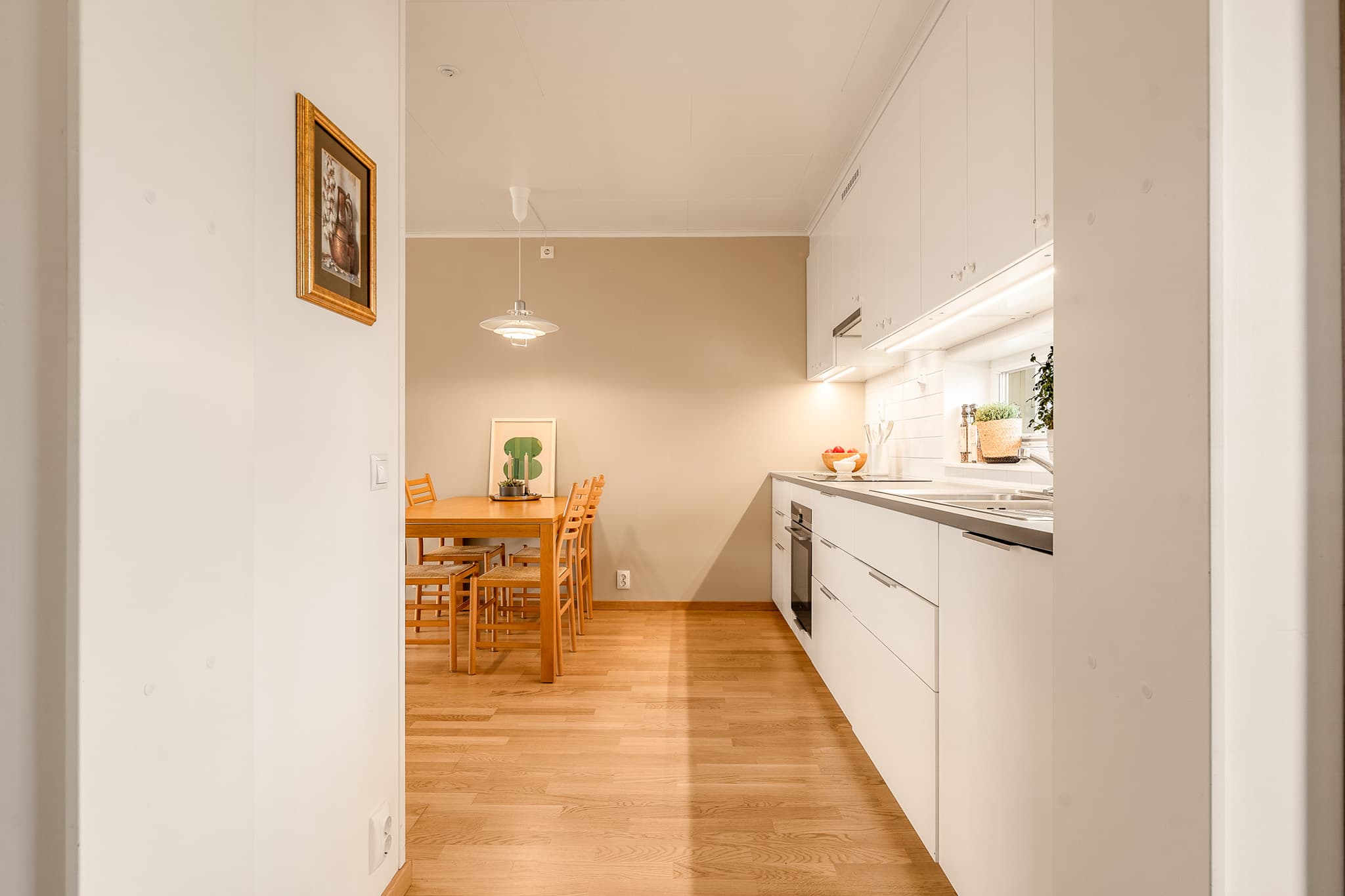 Oppholdsrommene i leiligheten har malte flater og parkett på gulv.