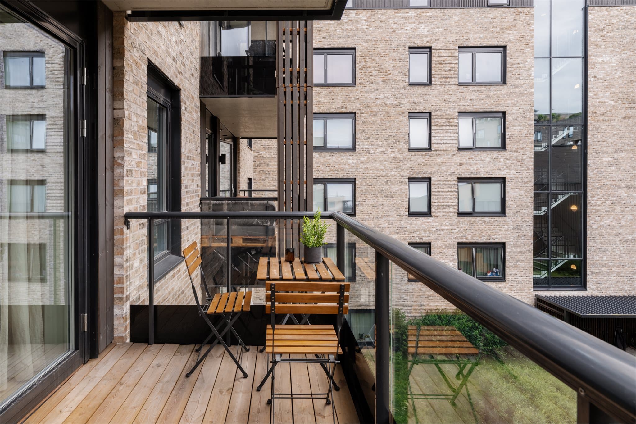 Balkongen vender mot vest og har terrassebord på gulv.