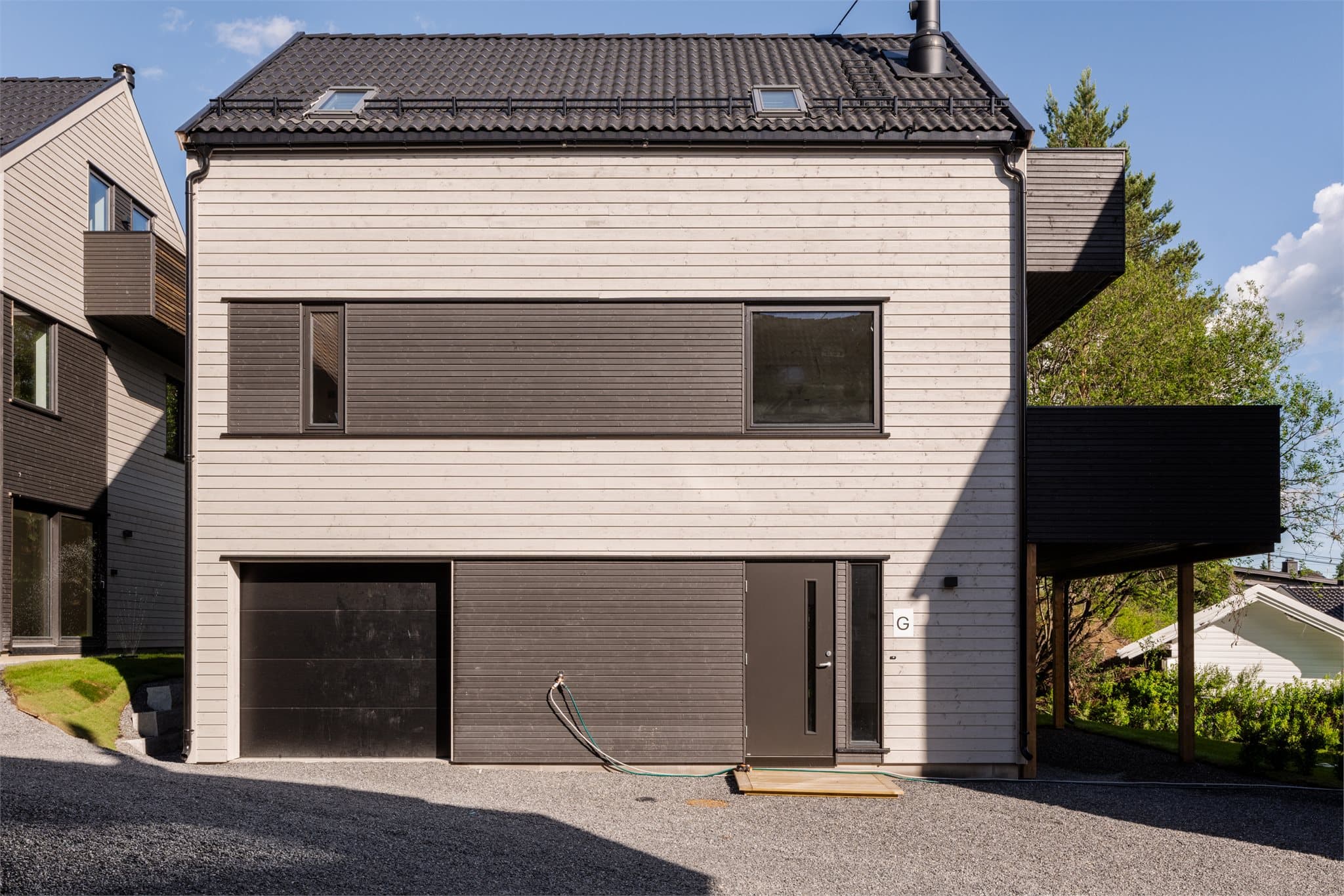 Garasje/carport er ferdigstilt med et moderne og helhetlig arkitektonisk uttrykk.