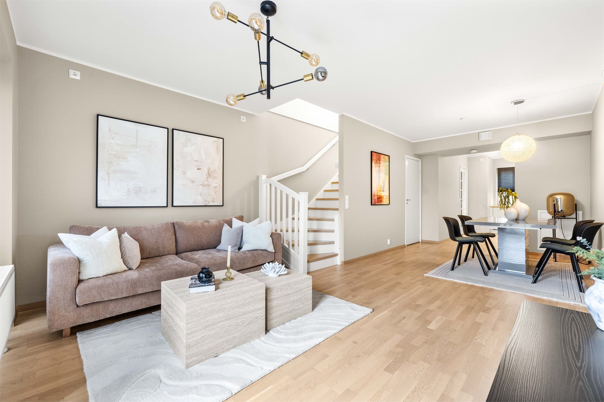 Stuen er et lyst og luftig rom med eikeparkett på gulvet og malte vegger.