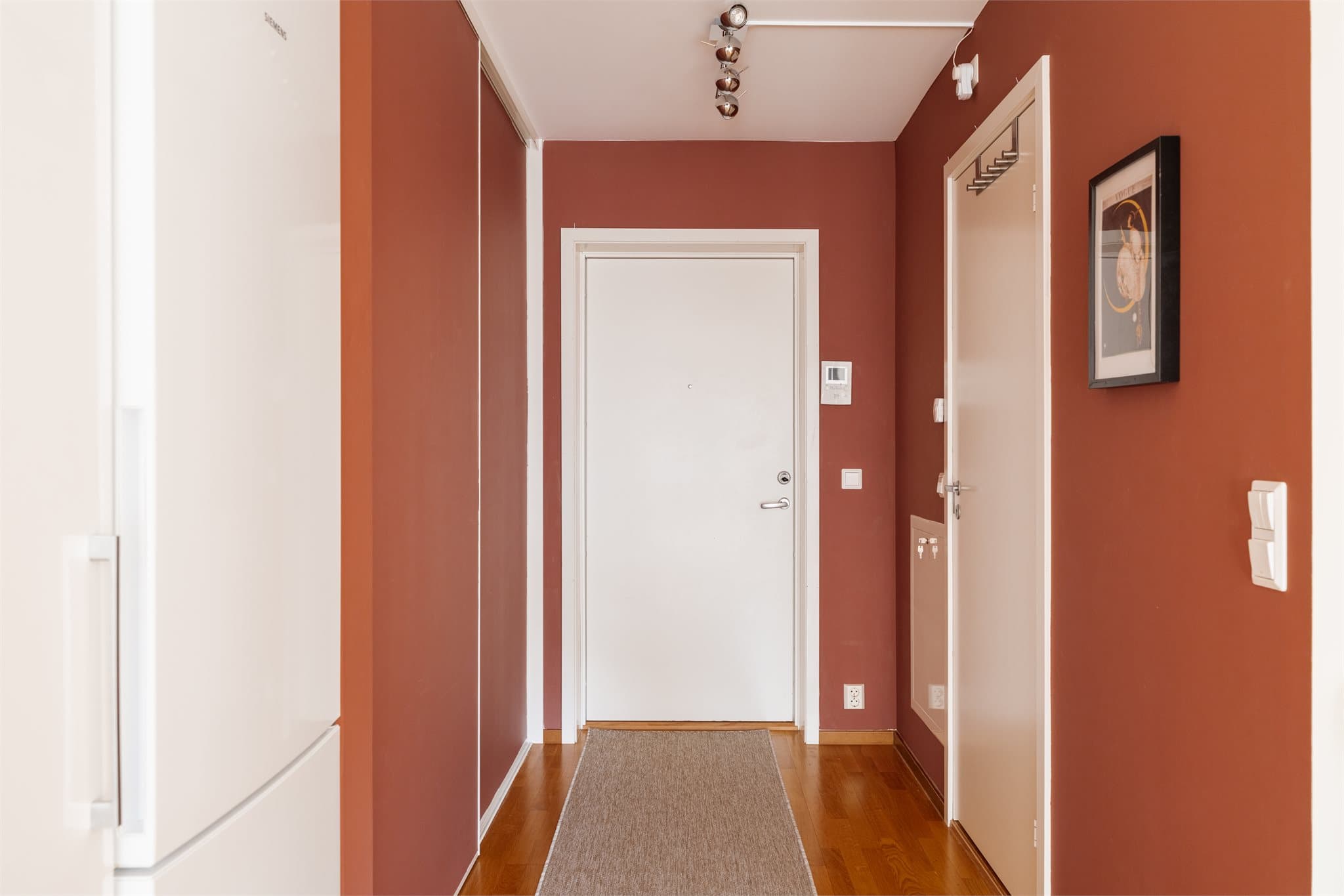 Entréen har en takhøyde på 2,50 meter og en plassbygget skyvedørsgarderobe for effektiv oppbevaring.