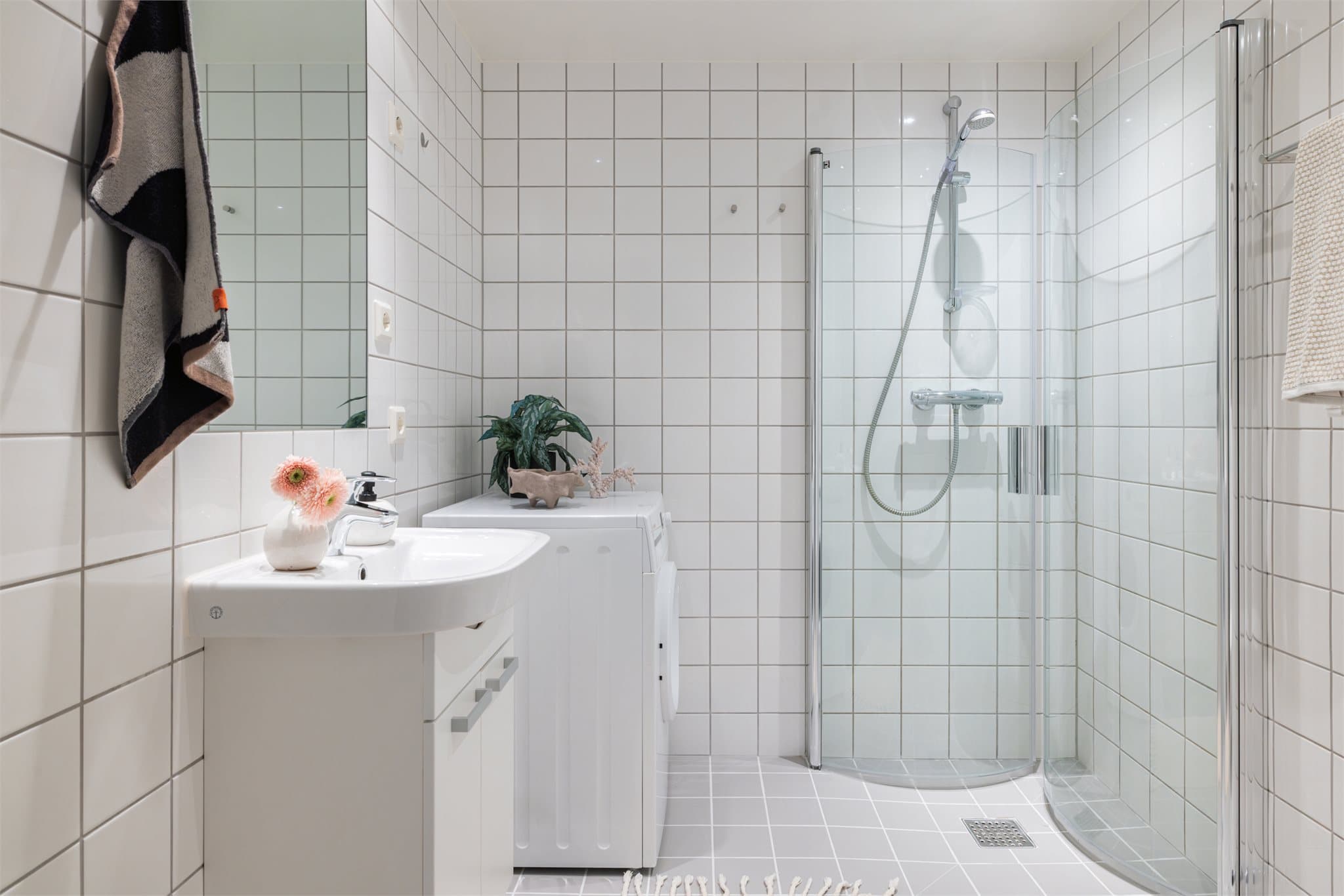 Servant med underskap og armatur samt speil over. Opplegg til vaskemaskin og tørketrommel.