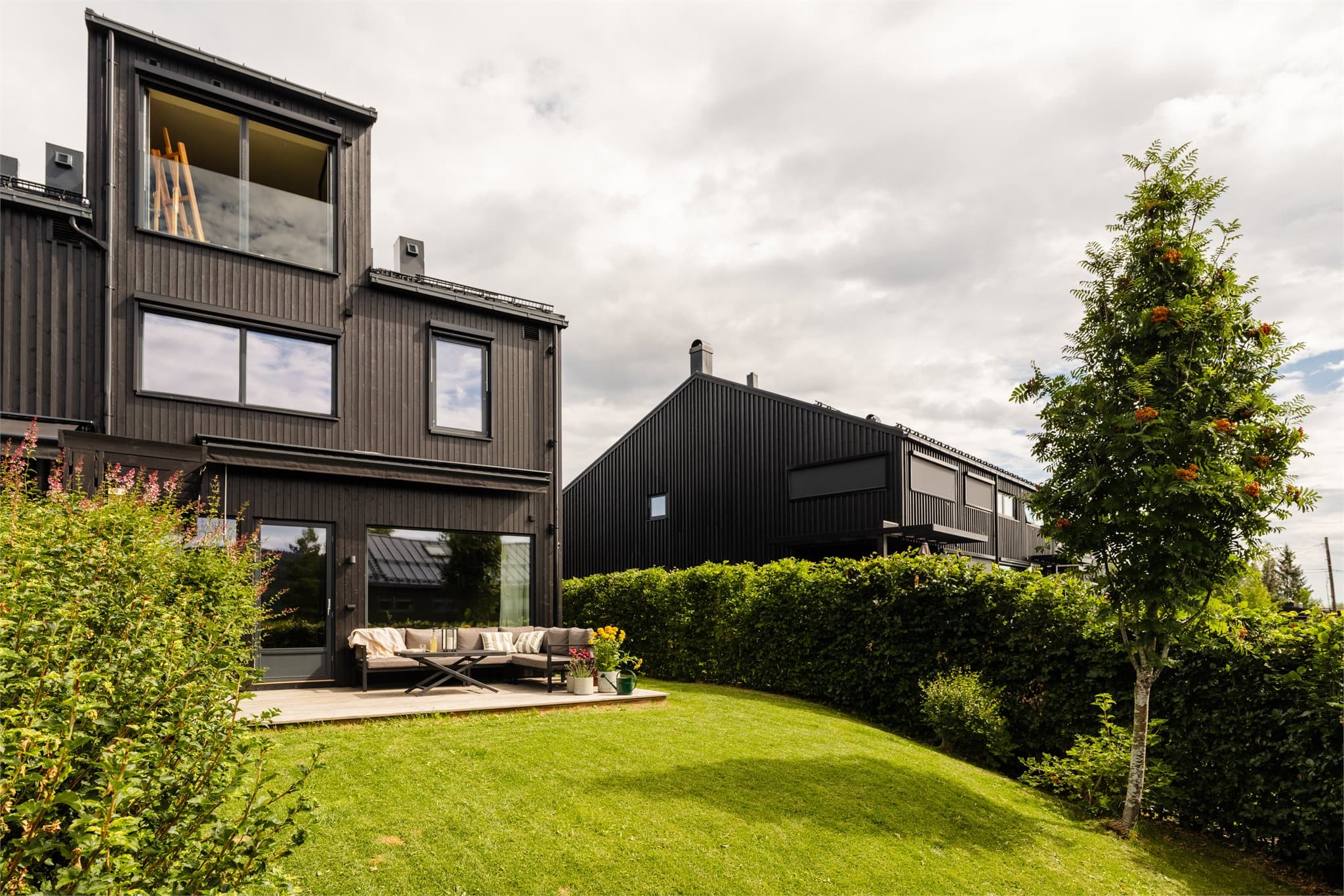 Moderne arkitektur og store vindusflater mot hagen.