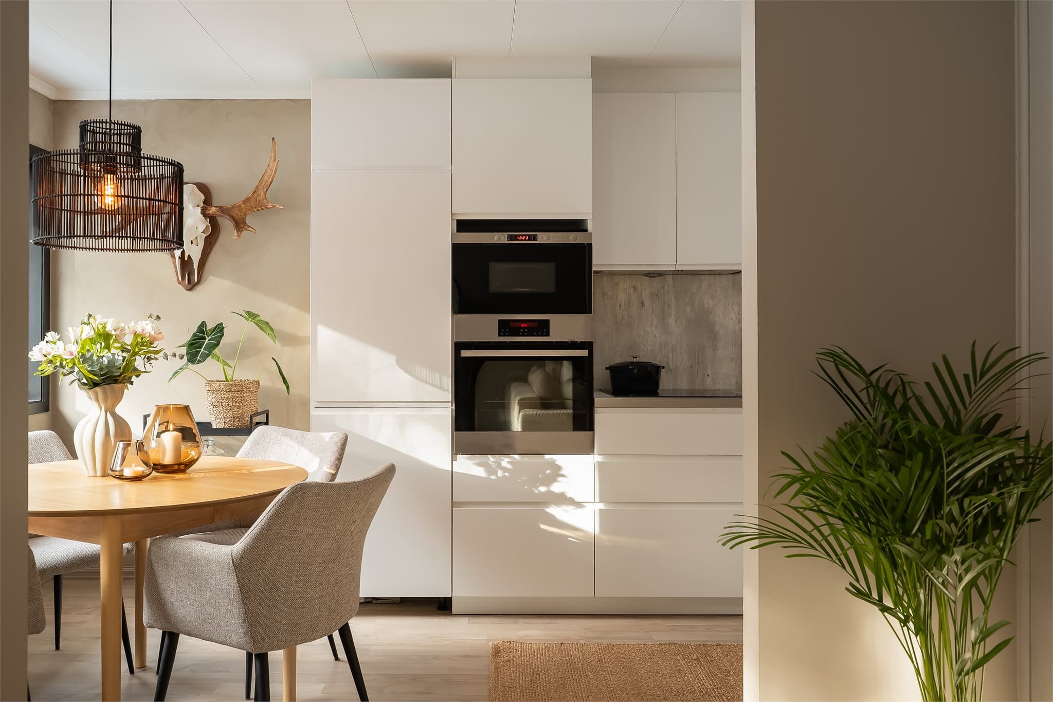 Delvis åpen løsning mellom stue og kjøkken skaper en sosial sone. Leiligheten har store vindusflater som gir rikelig med dagslys.