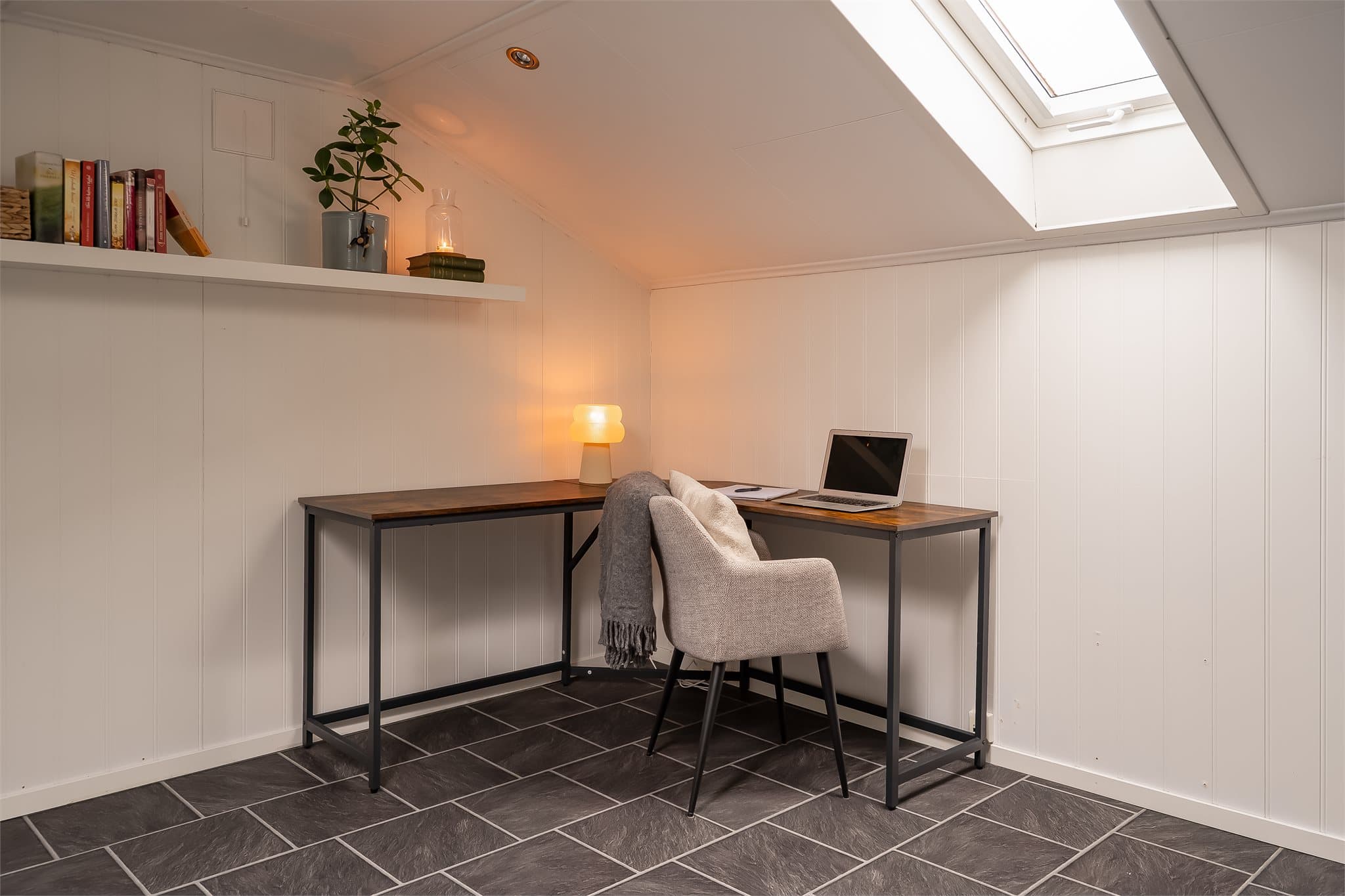 Loftsrom med takvindu som slipper inn naturlig lys.