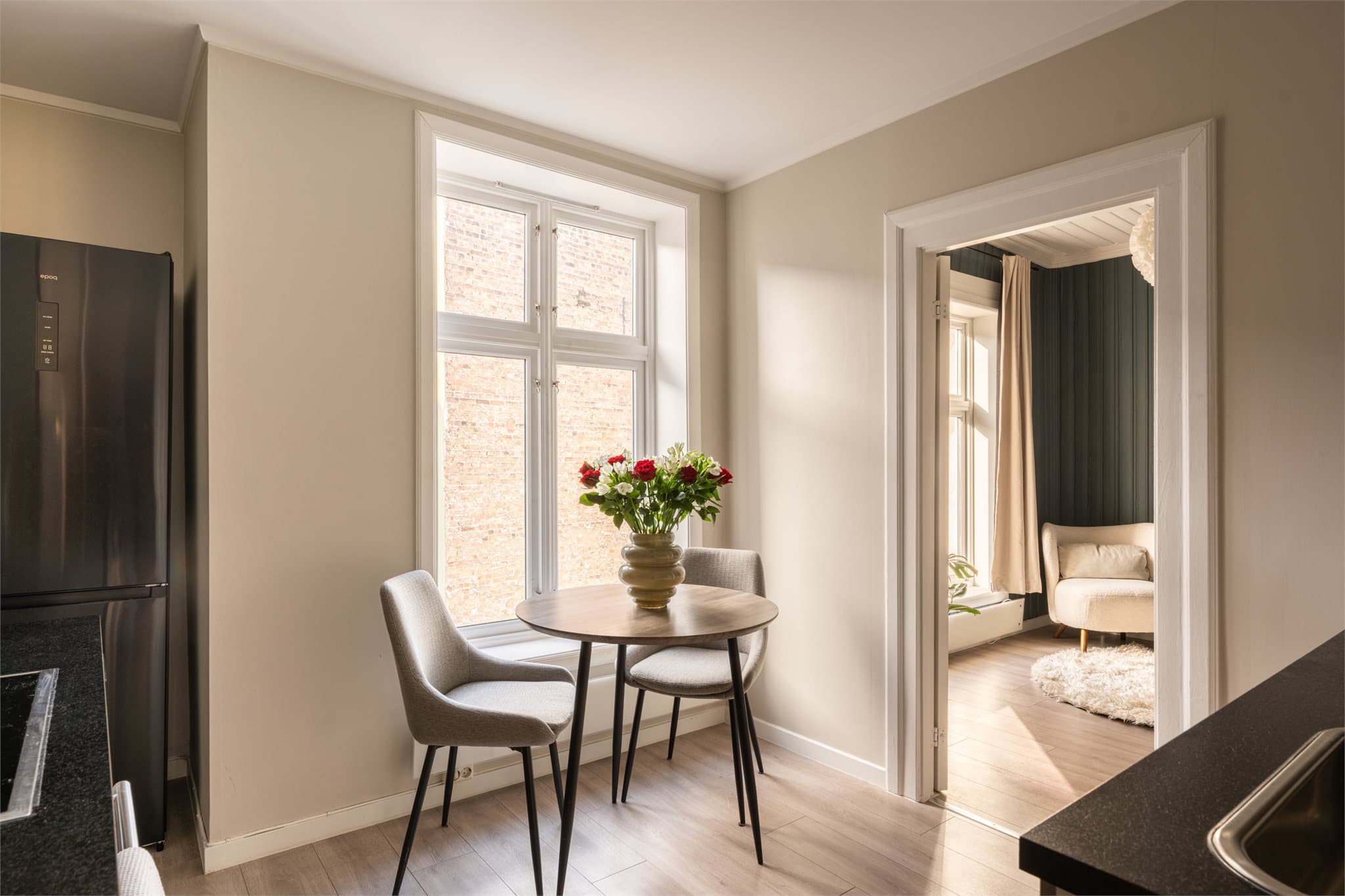 Store vinduer gir mye naturlig lys og det er plass til spisegruppe.