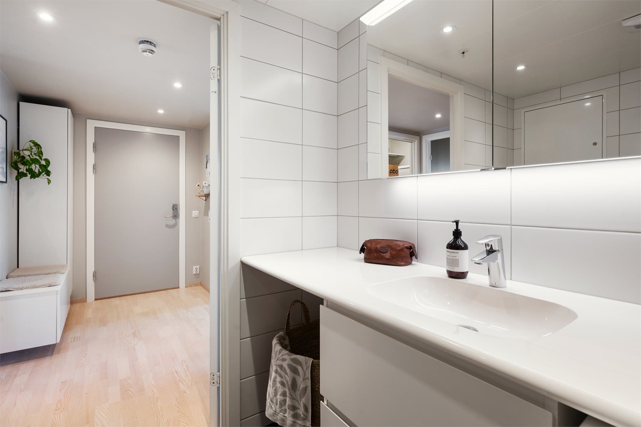 Baderomsinnredningen har nedfelt servant og speilskap med integrert belysning.