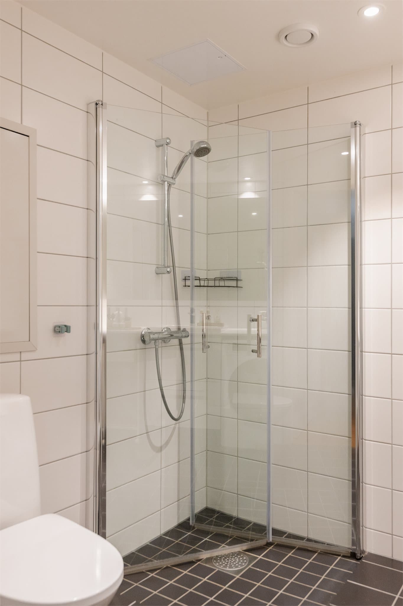 Dusjhjørne med innfellbare dører i herdet glass.
