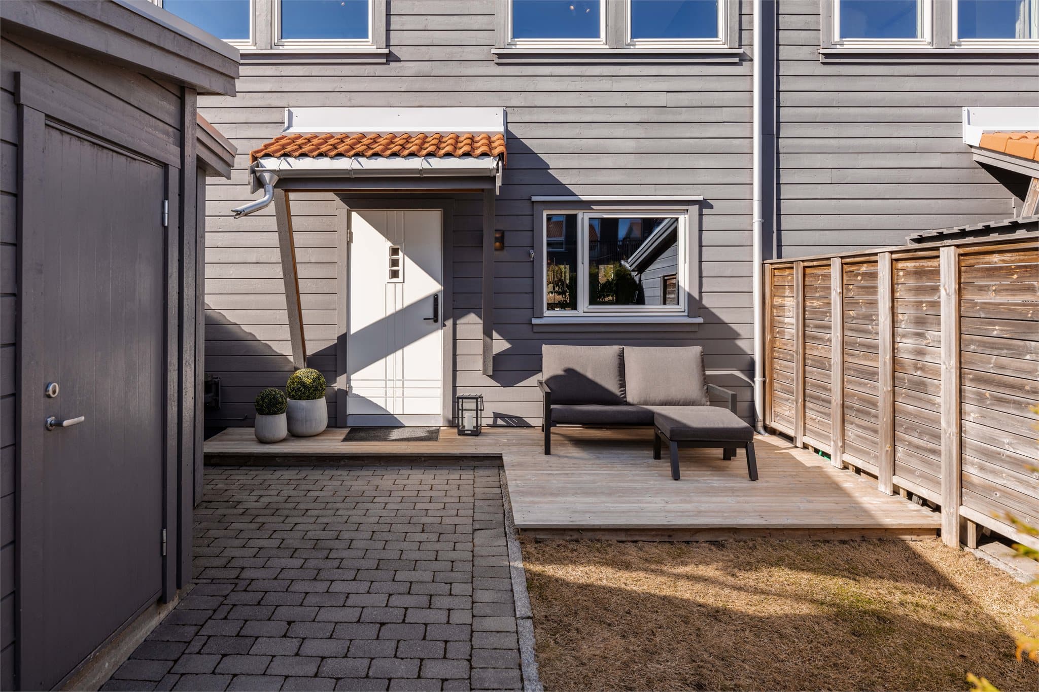 Boligen har et svært hyggelig inngangsparti med en flott og skjermet uteplass med morgensol, her er det plass til en koselig sittegruppe.