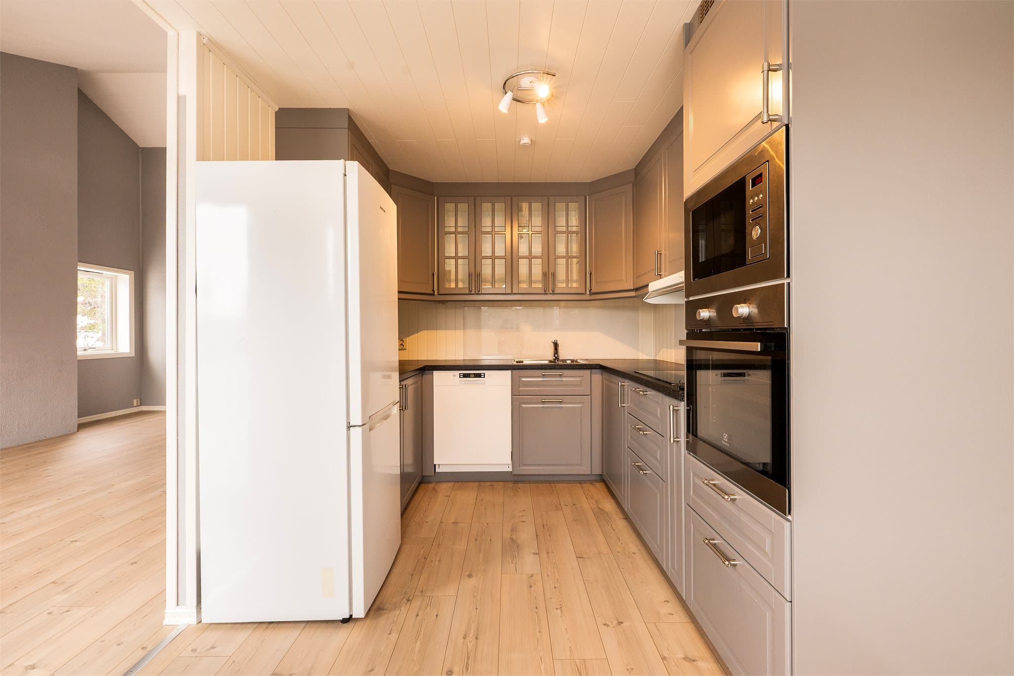 Tidløst og pent "Ikea" kjøkkeninnredning fra 2016, i henhold til opplysninger fra eier. Innredning med glatte, fabrikklakkerte fronter og benkeplate i laminat med nedfelt kum i rustfritt stål. Det er glassplate på vegg over benk.