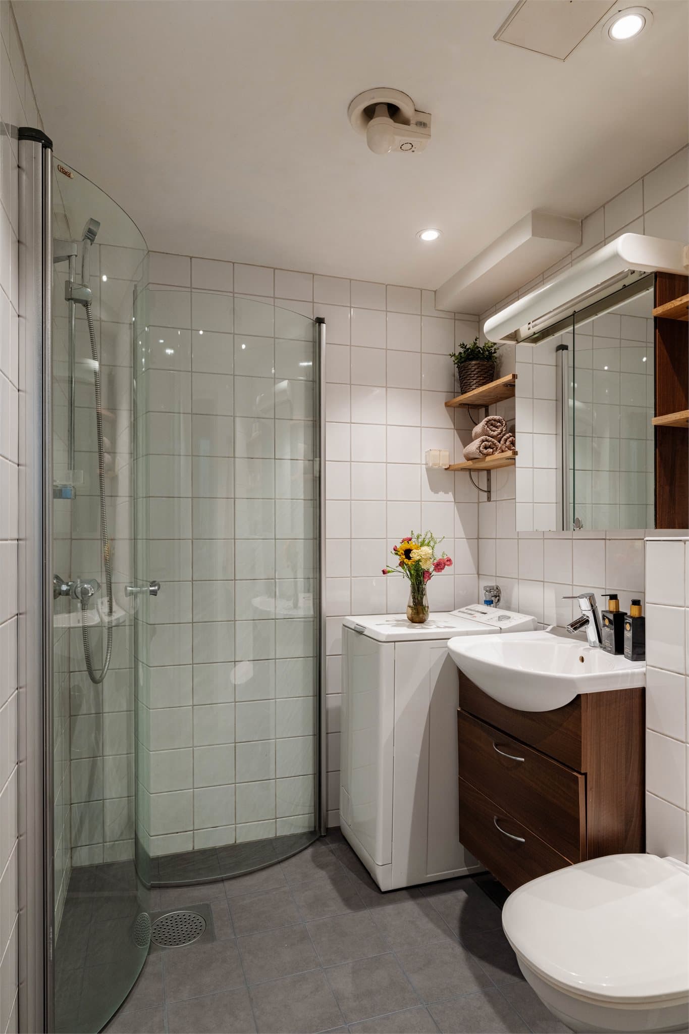Badet har vegghengt toalett, dusjhjørne, varme i gulv og opplegg for vaskemaskin.