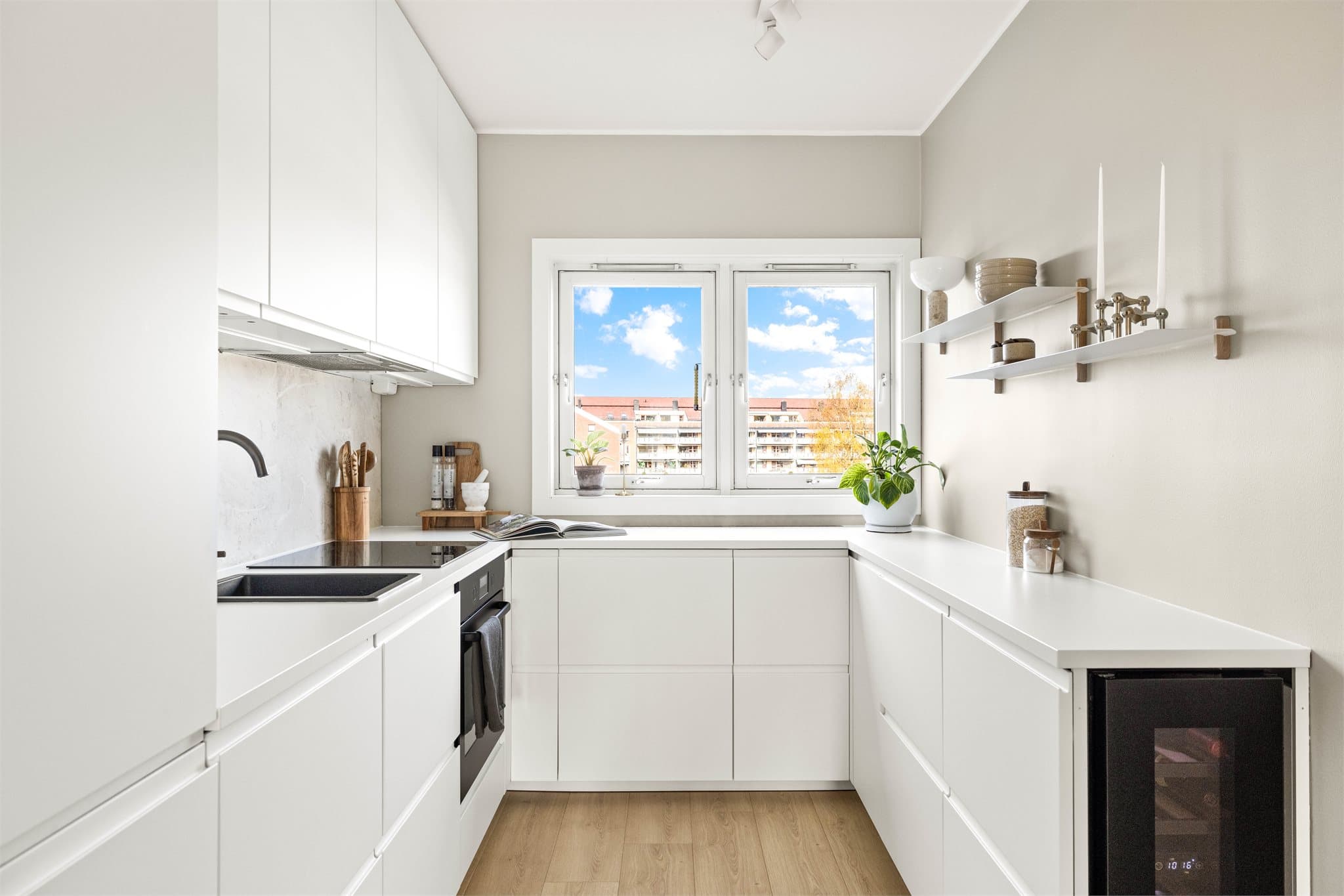 Kjøkkenet er stilrent og praktisk, med integrerte hvitevarer og gode arbeidsflater.