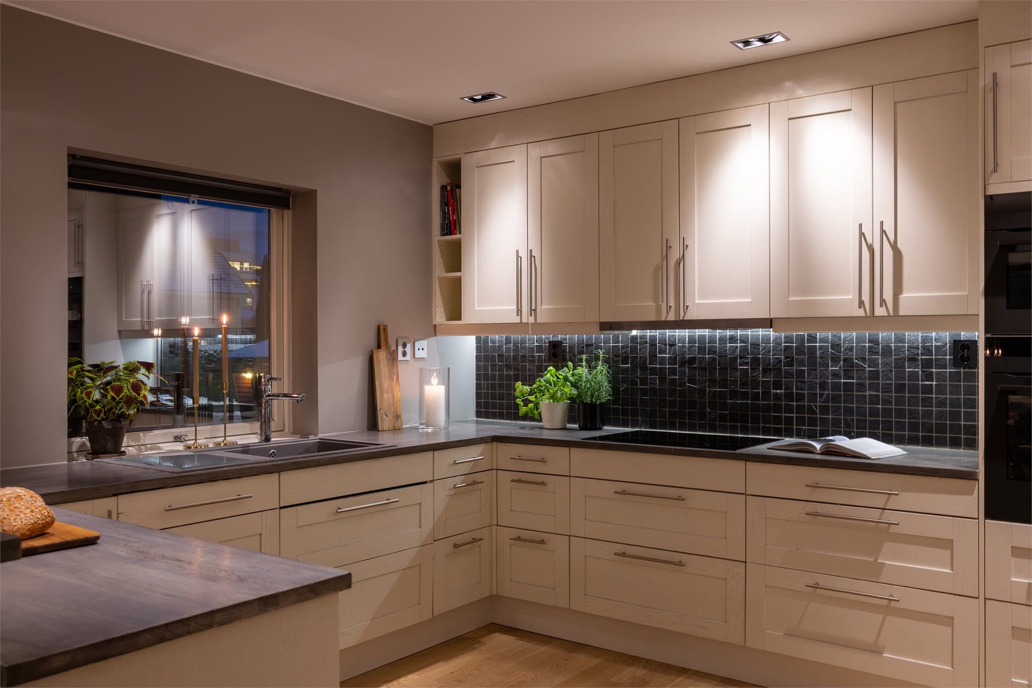 Over benkeskapene er det fliser som gir et klassisk uttrykk. Her får du nok av benkeplass, oppbevaring og en sosial sone for hele familien.