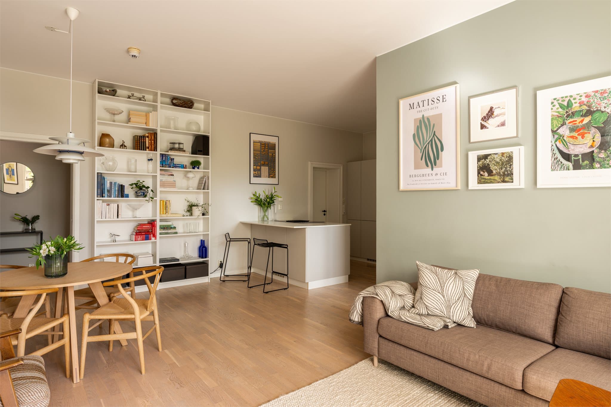 Den åpne løsningen gir rom for både spiseplass og sofagruppe, ideelt for sosiale sammenkomster.